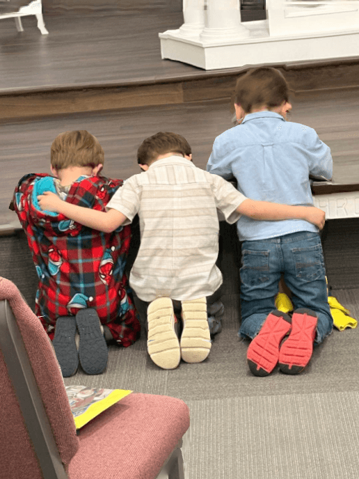 Children praying at Gethsemane Church in Pekin Illinois